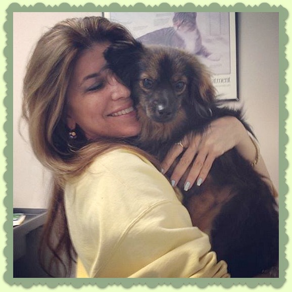 Woman happily hugging her dog after being reunited